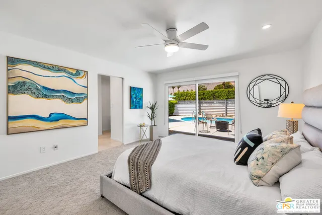 a bedroom with furniture and a large window