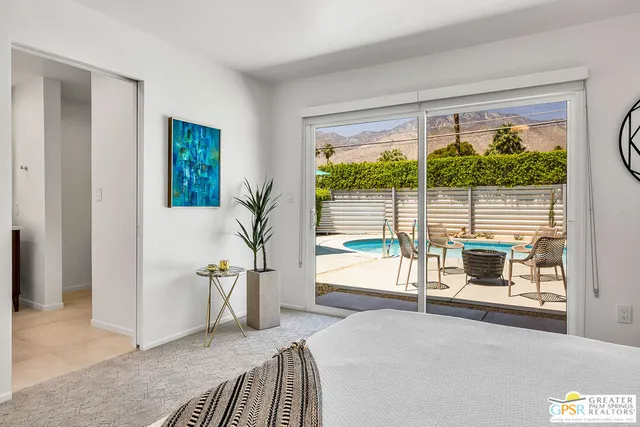 a bedroom with furniture and a window