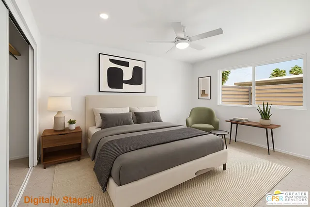 a spacious bedroom with a bed and a chandelier