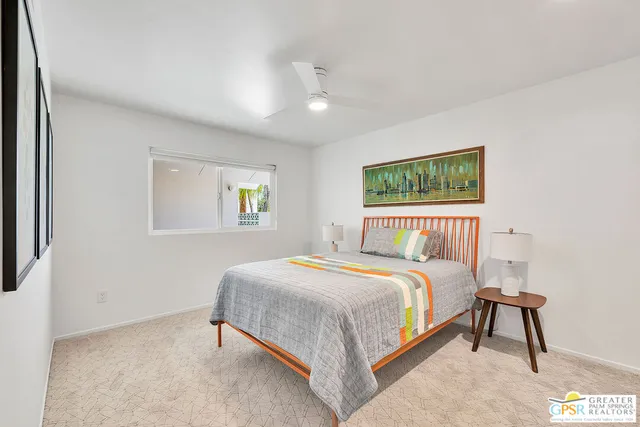 a bedroom with a bed and a night stand