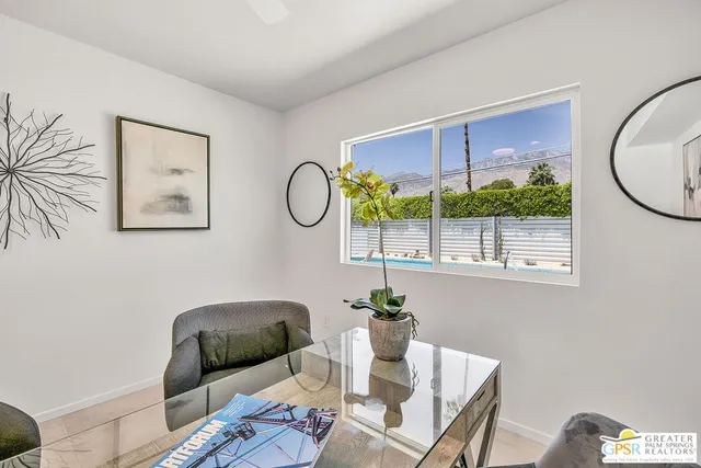 a living room with furniture and a potted plant