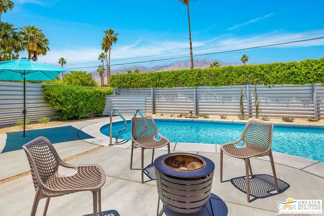 a view of a chairs and table in the patio
