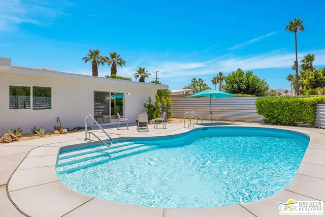 a view of a house with backyard porch and sitting area