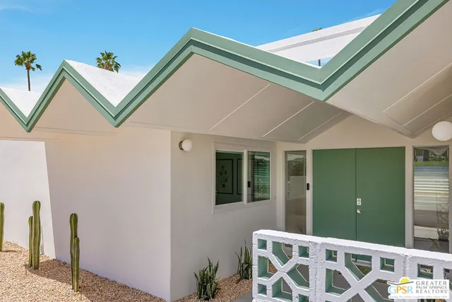 a view of an chairs and table in the house
