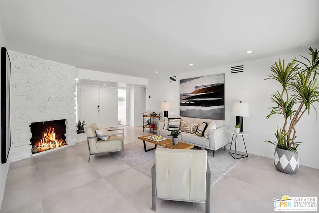 a living room with furniture fireplace and potted plant