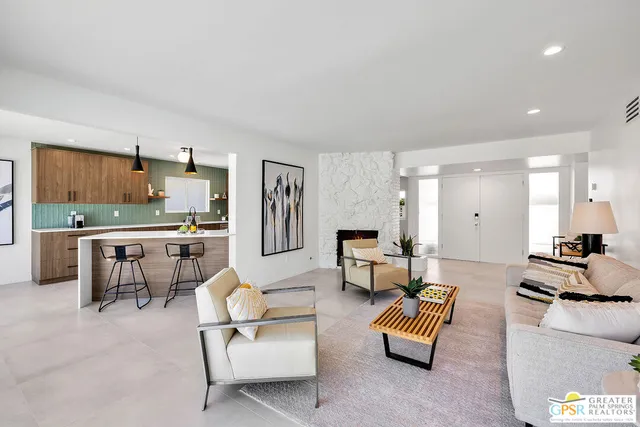 a living room with furniture and kitchen view