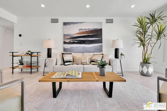 a living room with furniture a table and potted plants