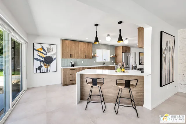 a kitchen with stainless steel appliances a refrigerator and a stove top oven