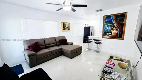 a living room with furniture and a flat screen tv