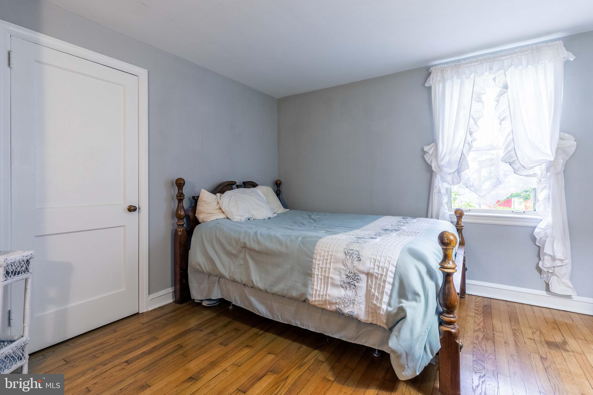 1042 Thrush Lane Norristown, PA 19403 - Photo 17 of 30 a bedroom with a bed and wooden floor