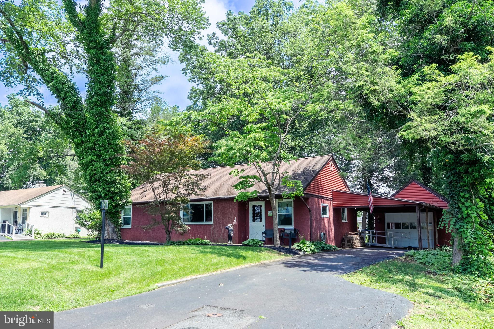 1042 Thrush Lane Norristown, PA 19403 - Photo 24 of 30 a view of a big yard in front of a brick house with large windows