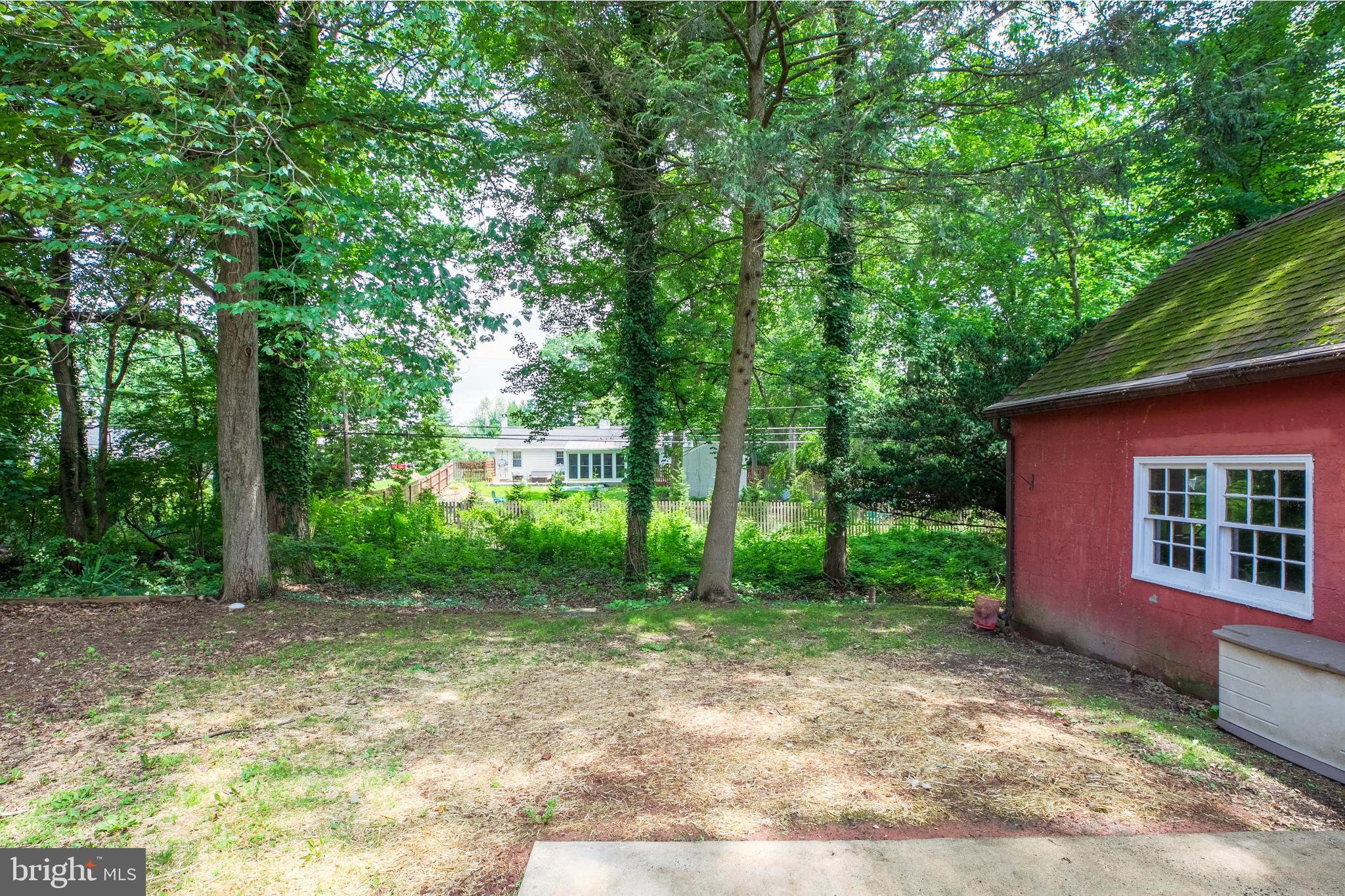 1042 Thrush Lane Norristown, PA 19403 - Photo 26 of 30 a view of a backyard with large trees and plants