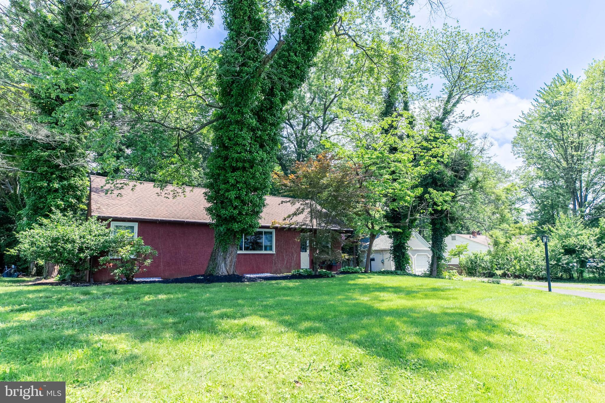 1042 Thrush Lane Norristown, PA 19403 - Photo 29 of 30 a view of a backyard with table and chairs plants and large trees