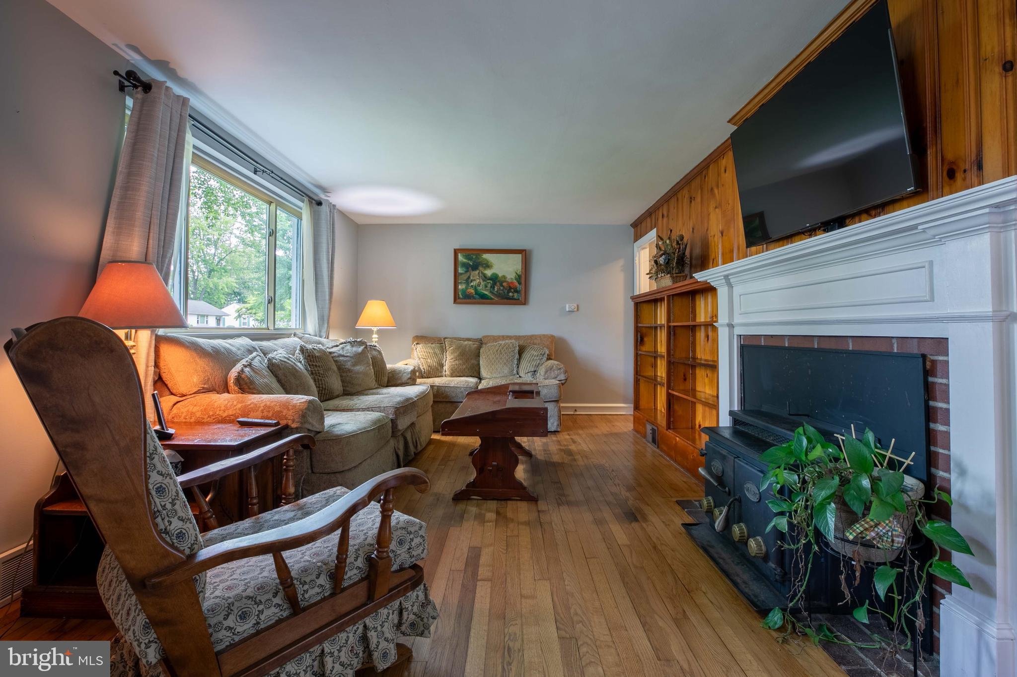 1042 Thrush Lane Norristown, PA 19403 - Photo 4 of 30 a living room with furniture a flat screen tv and a fireplace
