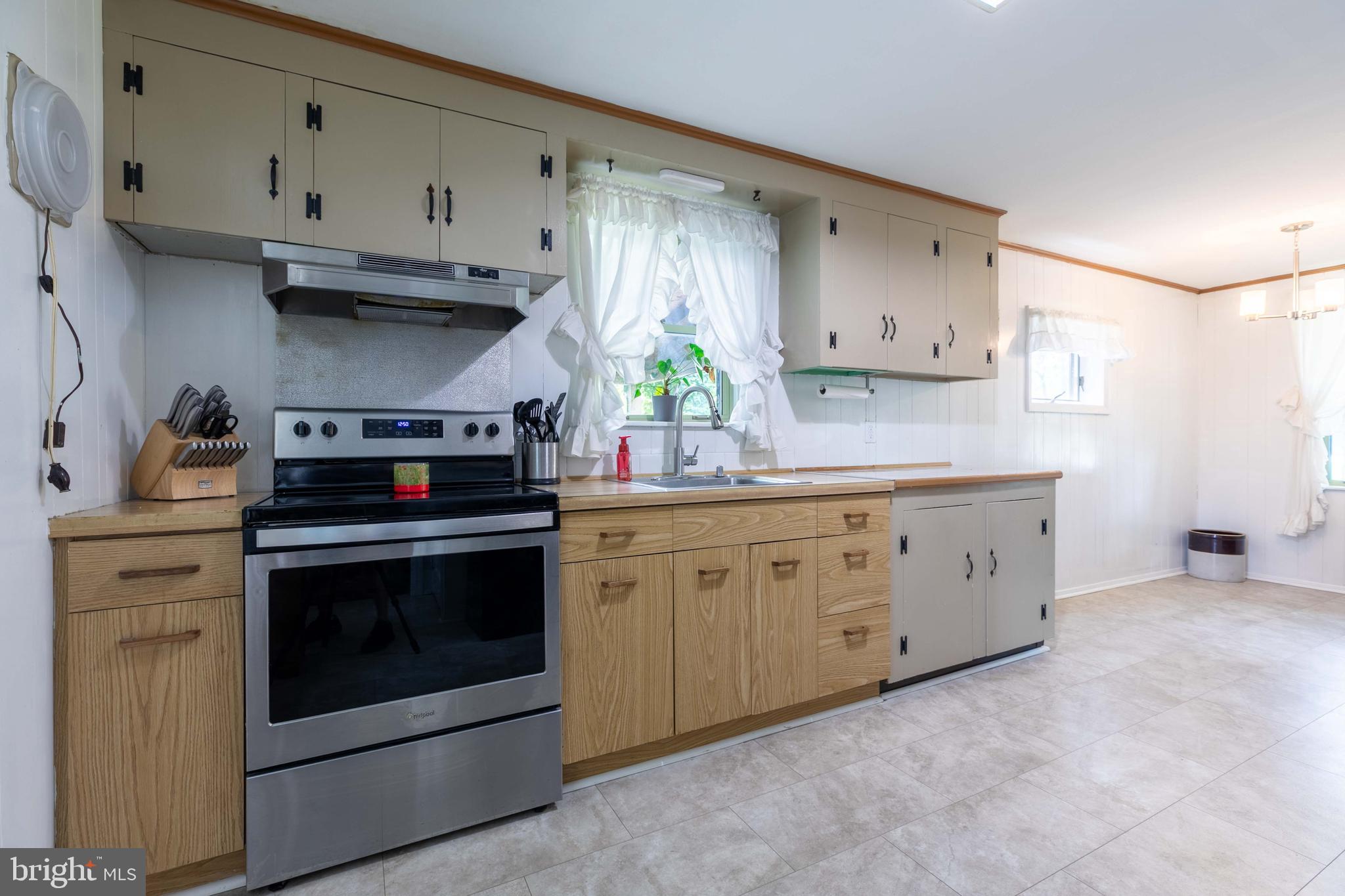 1042 Thrush Lane Norristown, PA 19403 - Photo 7 of 30 a kitchen with stainless steel appliances white cabinets and white appliances