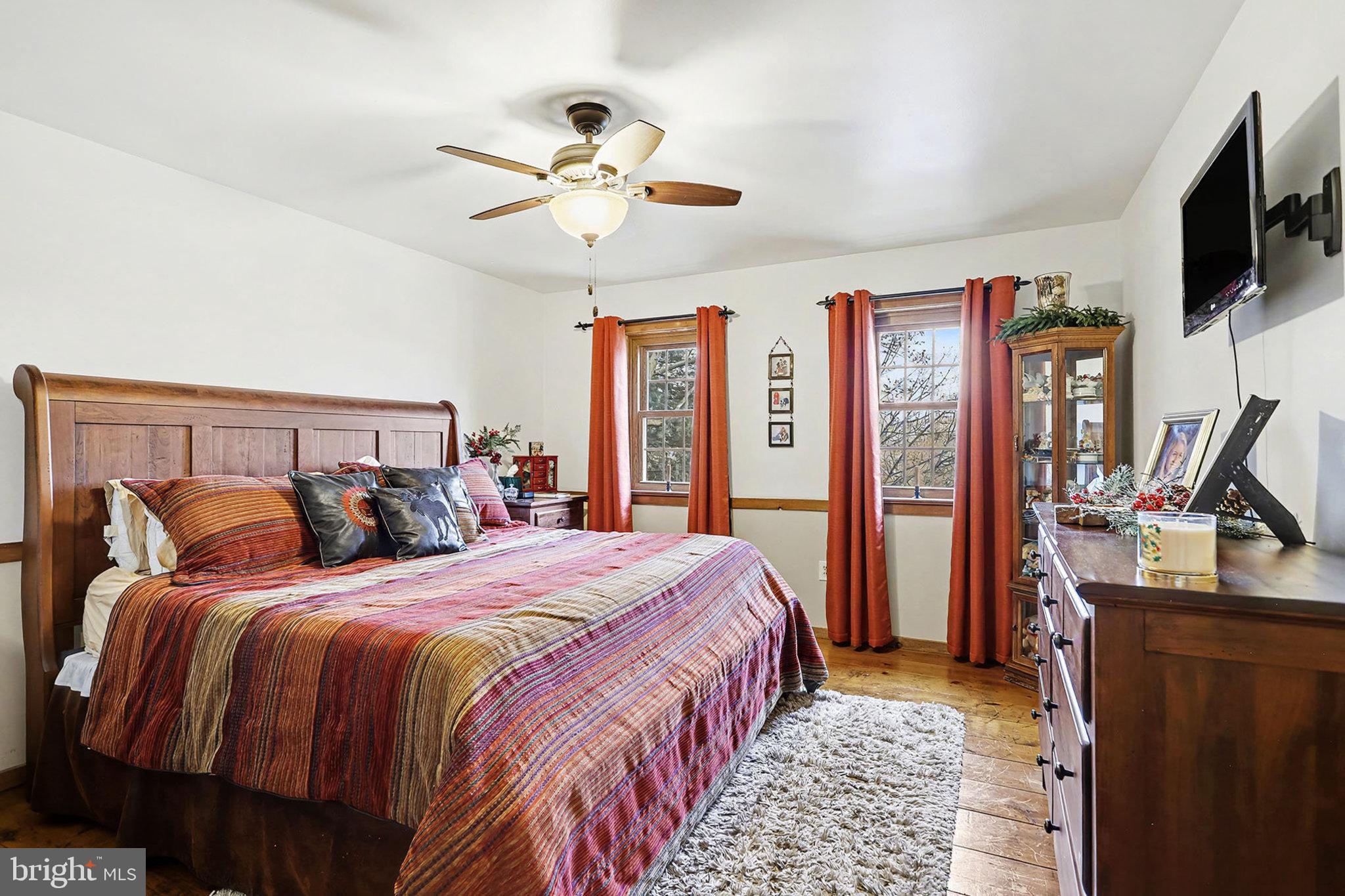 27 Ridge Road Lititz, PA 17543 - Photo 32 of 61 a bedroom with a bed and a flat tv screen on dresser