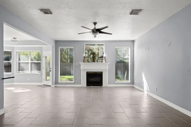 a view of a livingroom with a fireplace and windows