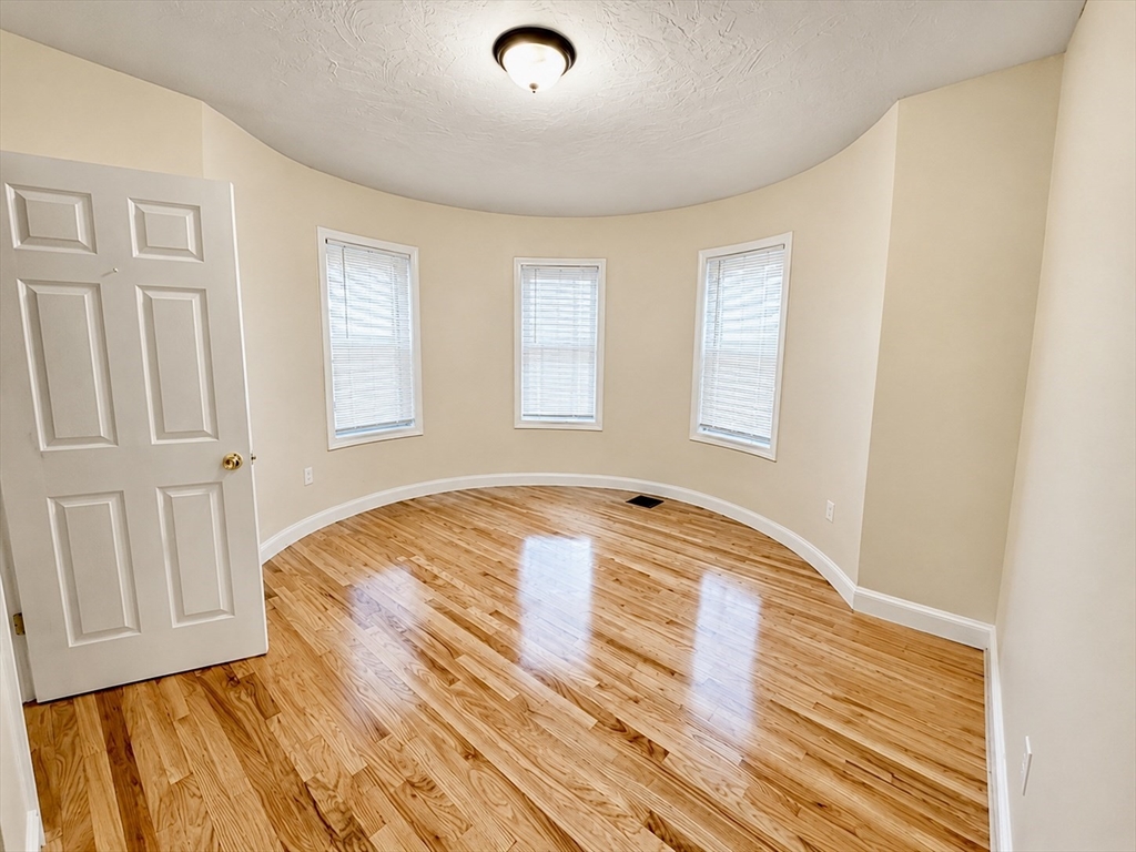 19 Dunlap Street, Unit 1 Boston, MA 02124 - Photo 1 of 9 a view of empty room with wooden floor