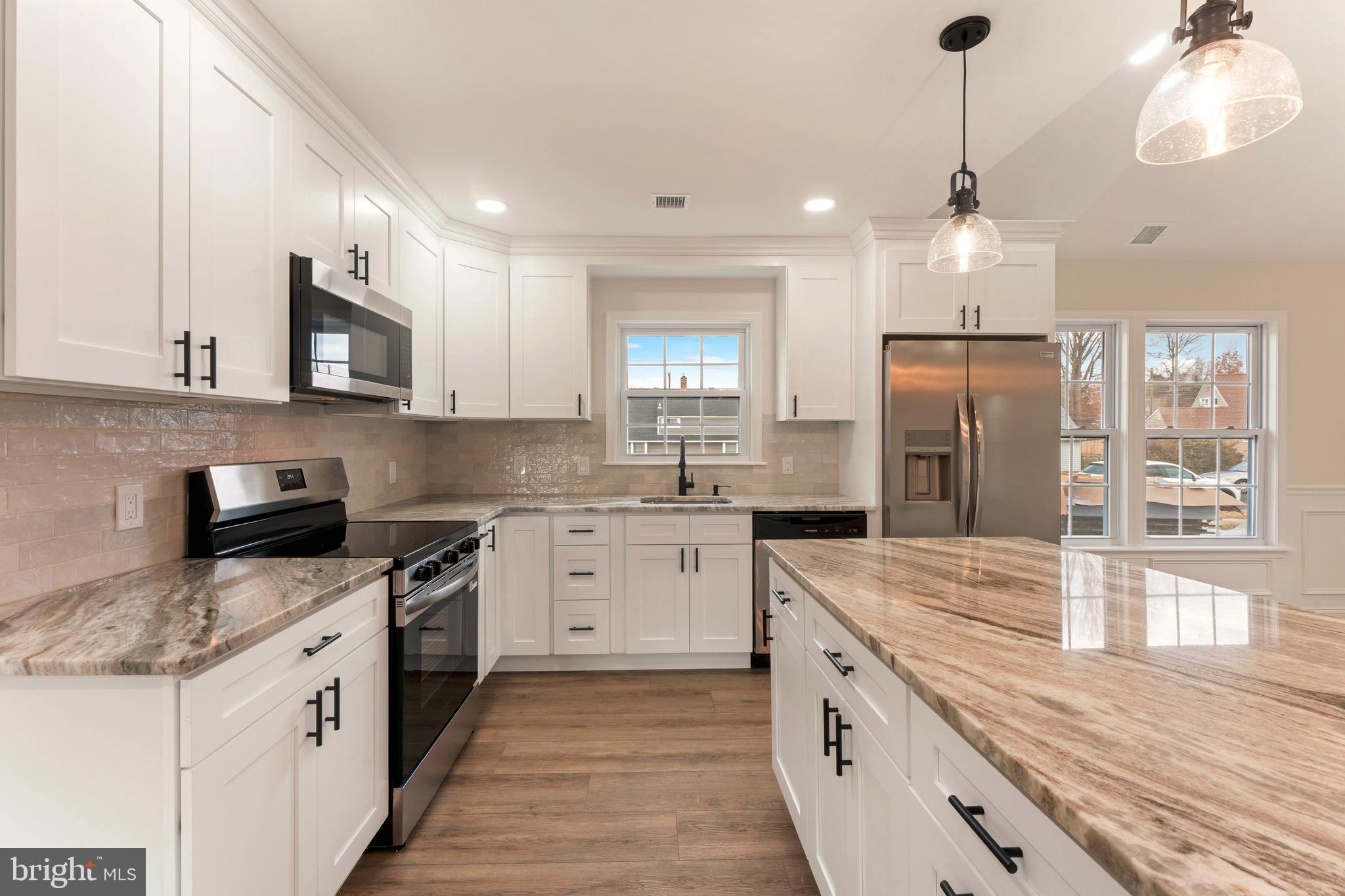 122 Ivy Hill Road Levittown, PA 19057 - Photo 11 of 36 a large kitchen with stainless steel appliances granite countertop a stove a sink and a refrigerator