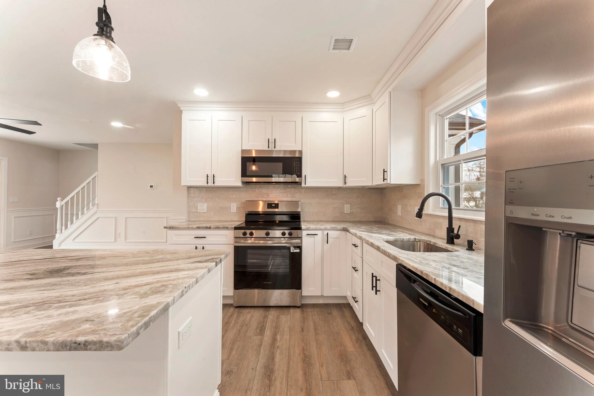 122 Ivy Hill Road Levittown, PA 19057 - Photo 12 of 36 a kitchen with stainless steel appliances granite countertop a sink and stove top oven