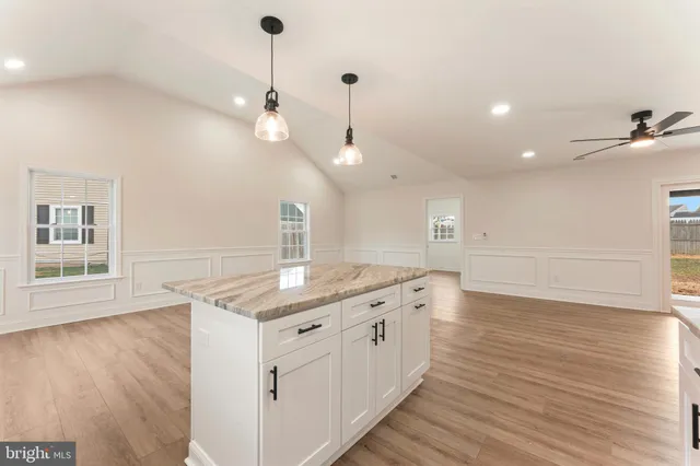 a kitchen with a sink and wooden floor