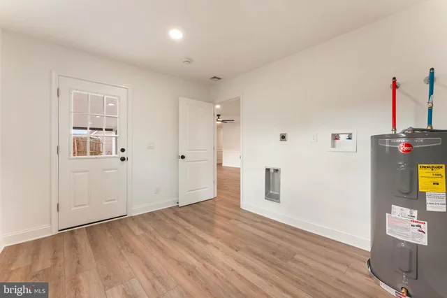 a view of a livingroom with wooden floor and a window