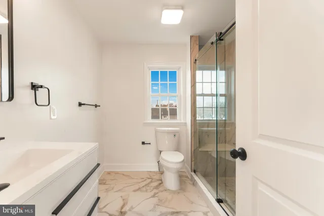 a bathroom with a shower and a sink