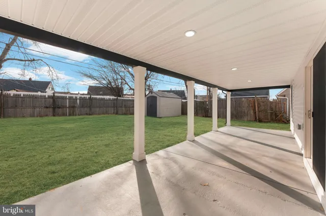 a view of a house with a big yard and potted plants