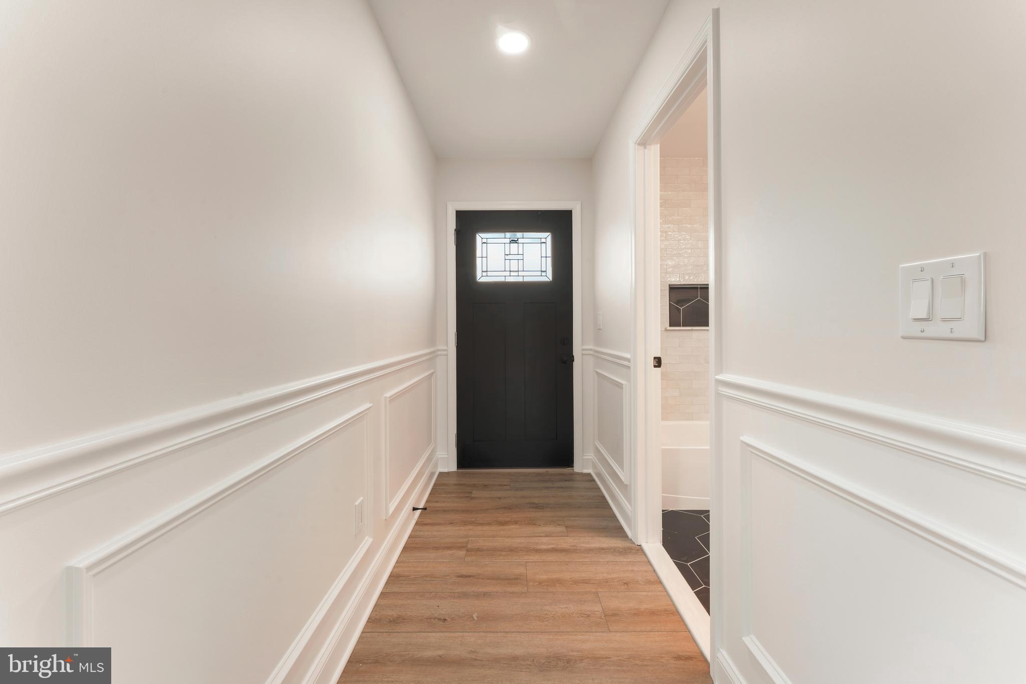 122 Ivy Hill Road Levittown, PA 19057 - Photo 6 of 36 a view of a hallway with wooden floor and staircase