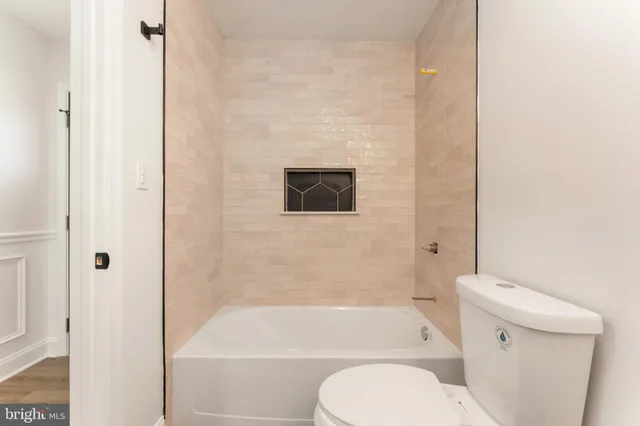 a bathroom with a toilet and a bathtub