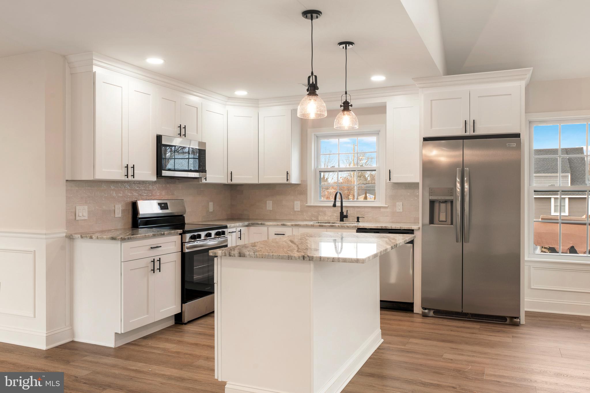 122 Ivy Hill Road Levittown, PA 19057 - Photo 9 of 36 a kitchen with stainless steel appliances granite countertop a refrigerator a stove a sink and a microwave