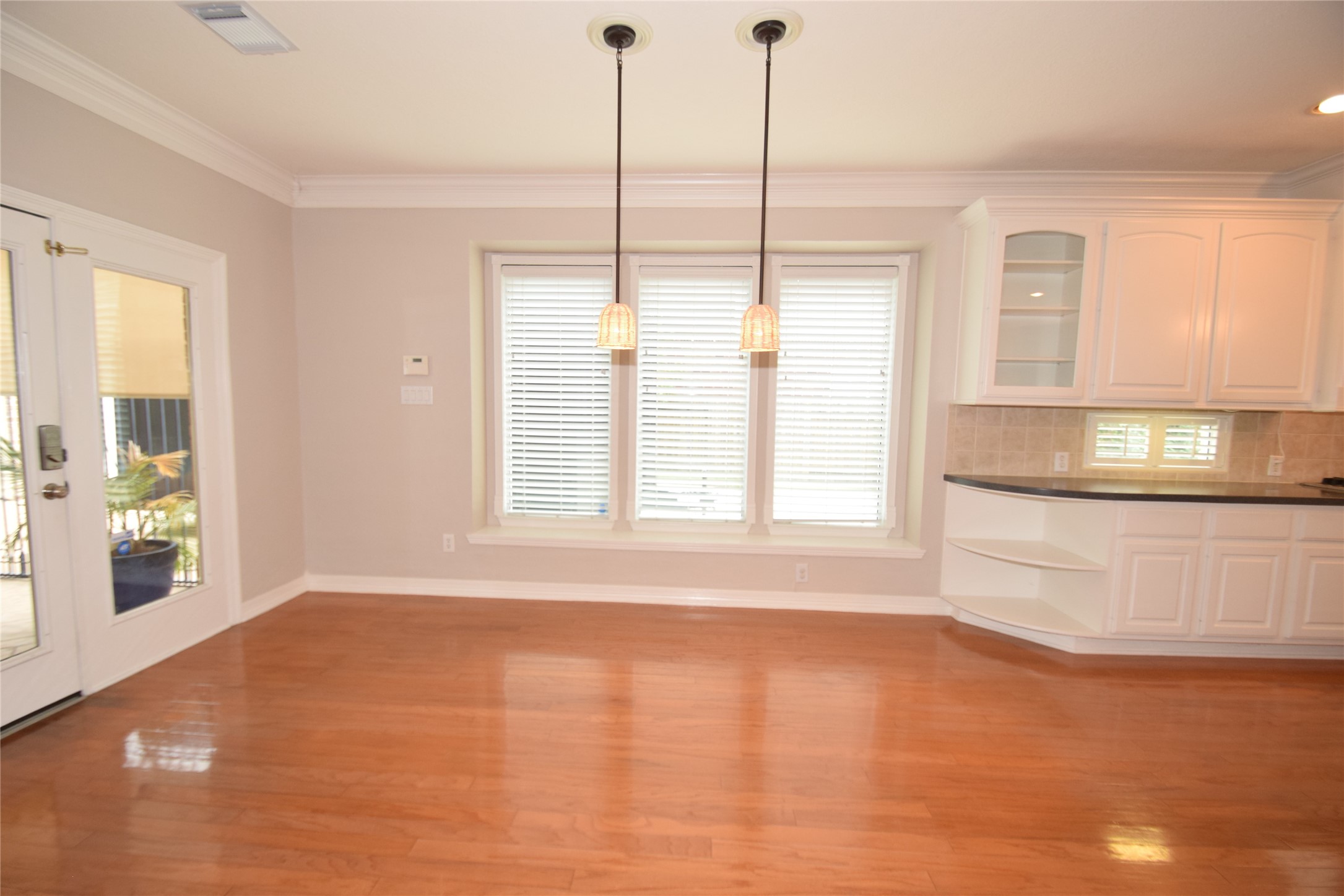 22018 Rustic Shores Lane Katy, TX 77450 - Photo 14 of 46 Breakfast room highlighted by hardwood floors, open to the kitchen and family room, access to the covered patio area and crown molding.