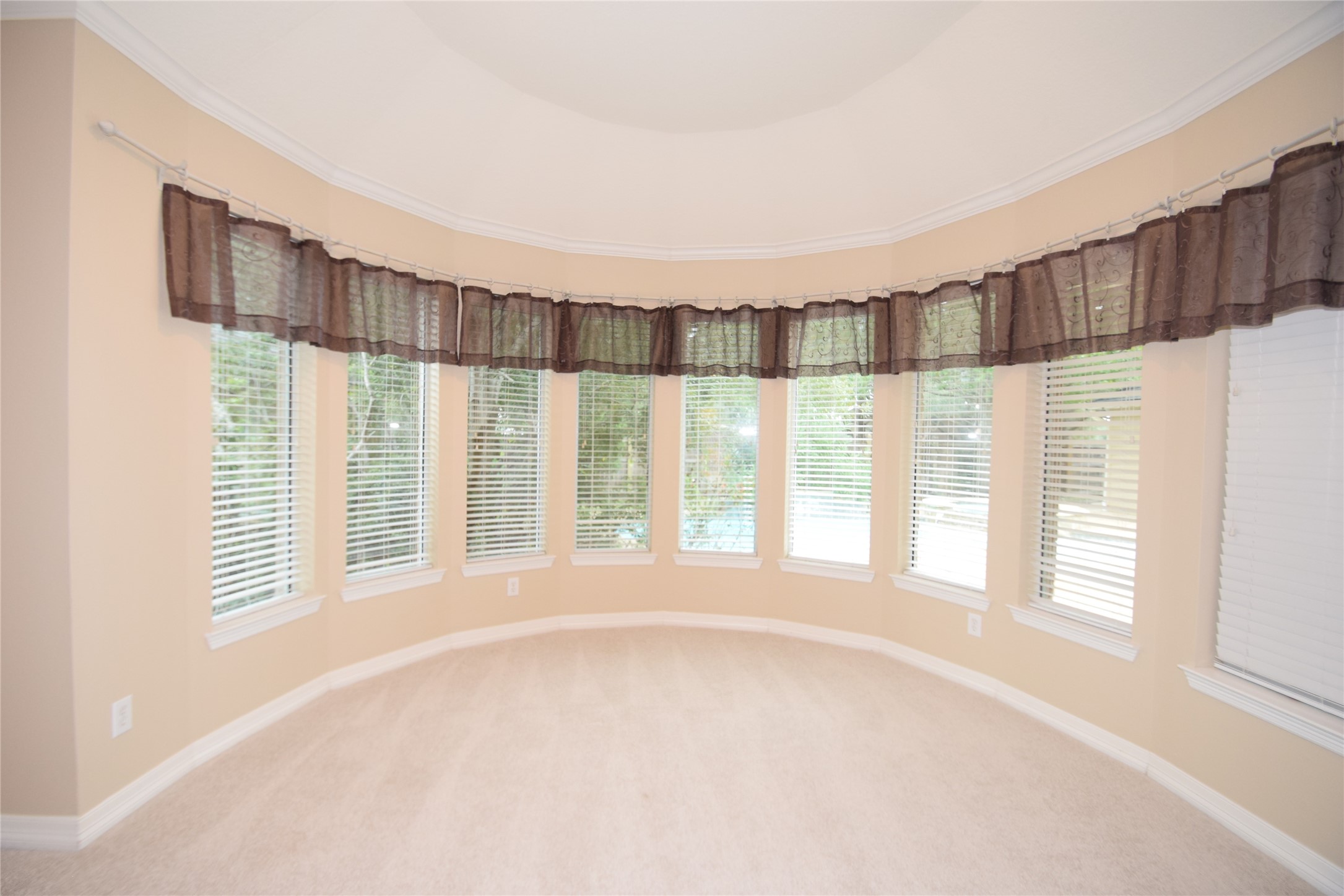 22018 Rustic Shores Lane Katy, TX 77450 - Photo 22 of 46 Sitting room in the primary suite surrounded by windows and raised ceilings.