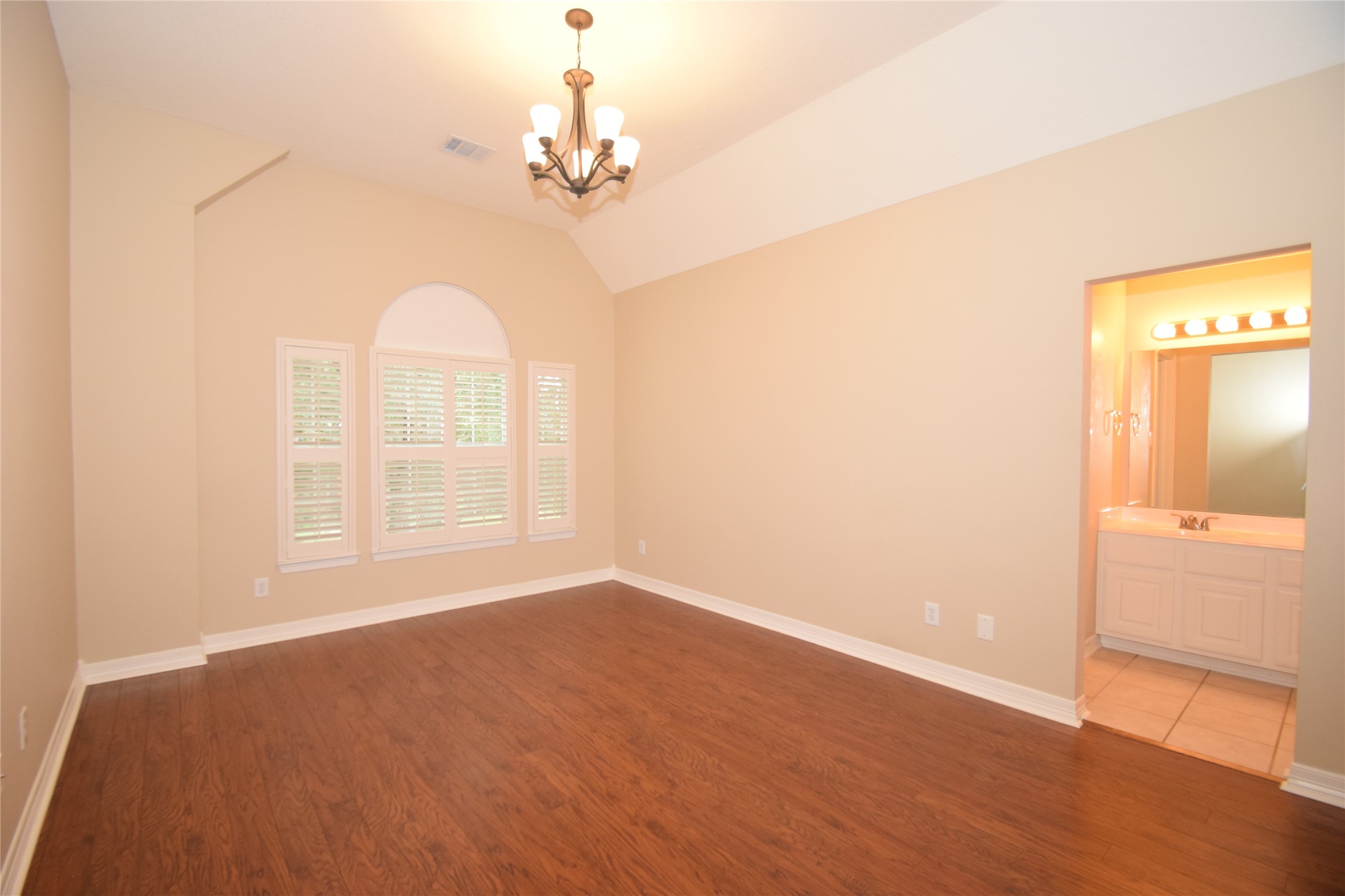 22018 Rustic Shores Lane Katy, TX 77450 - Photo 28 of 46 Bedroom upstairs with hardwood type floors, raised ceilings and access to a Hollywood style bath.