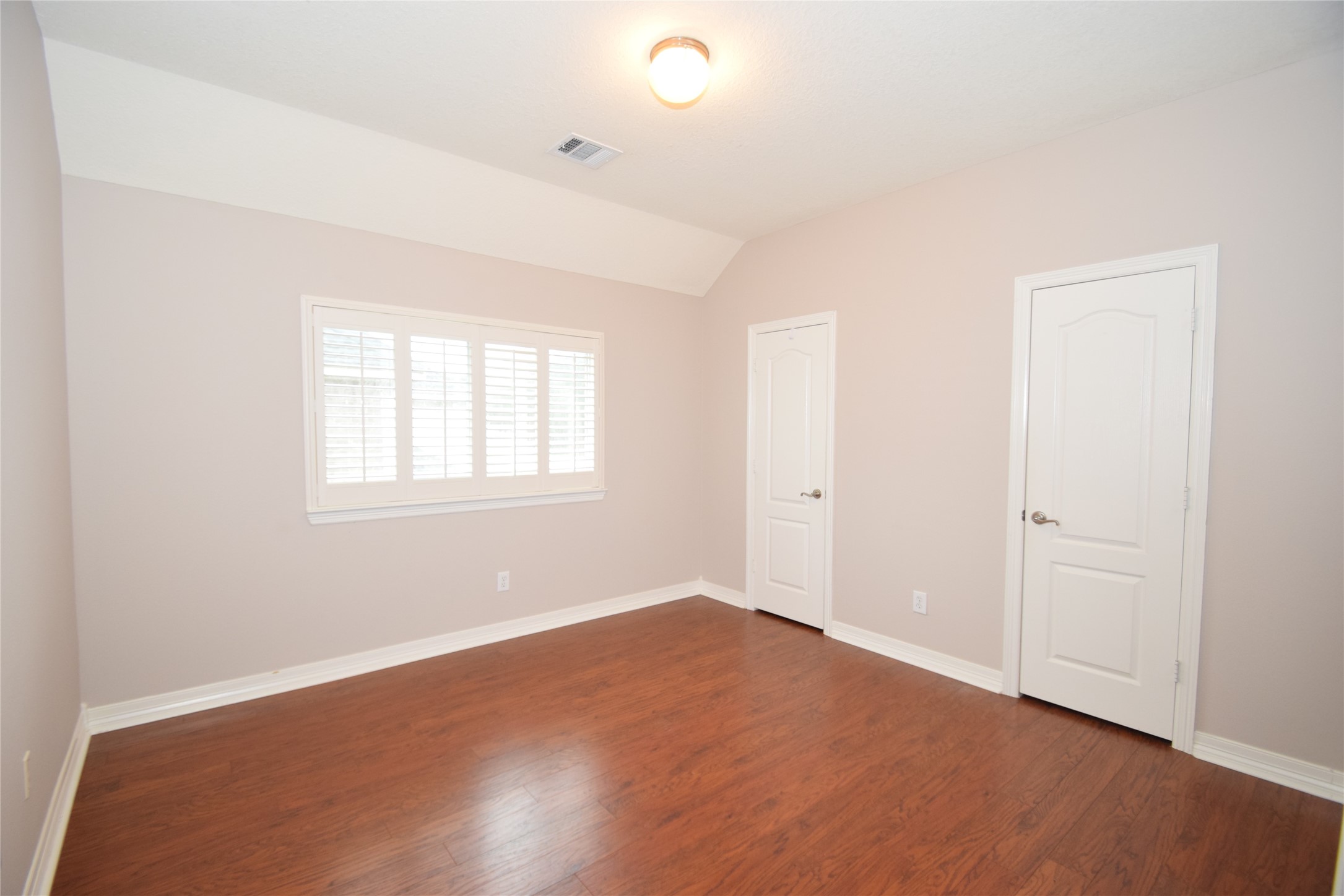 22018 Rustic Shores Lane Katy, TX 77450 - Photo 30 of 46 Bedroom with hardwood type flooring, raised ceilings and access to a Hollywood style bath with a tub/shower.