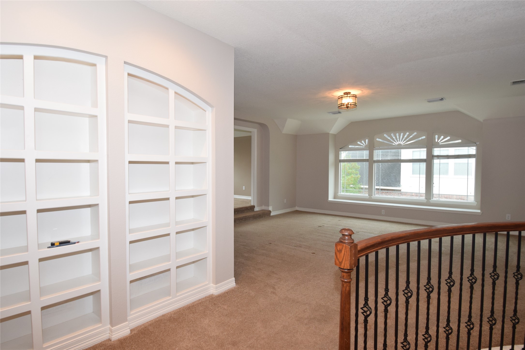 22018 Rustic Shores Lane Katy, TX 77450 - Photo 32 of 46 Beautiful built in bookshelves opening to the spacious game room with a raised card room.