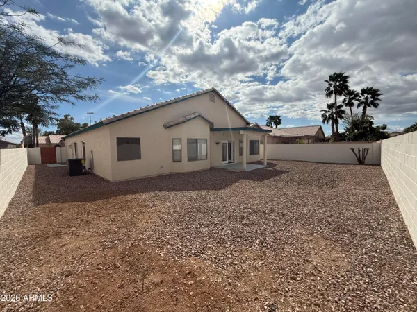 a view of a house with a backyard