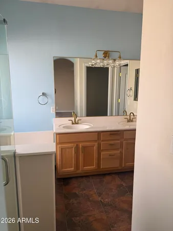 a bathroom with a double vanity sink and mirror