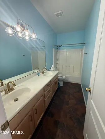 a bathroom with a double vanity sink and a mirror