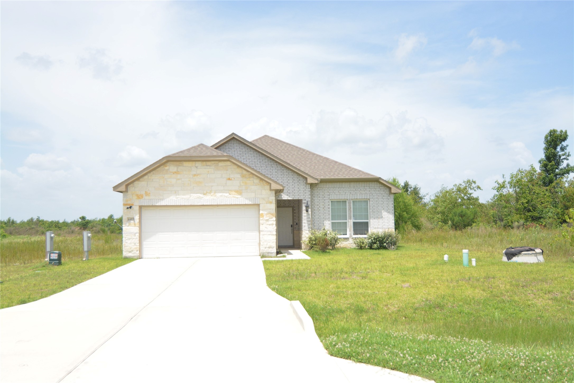 7714 Amanda Road Cleveland, TX 77327 - Photo 15 of 16 a view of a house with a yard and garage