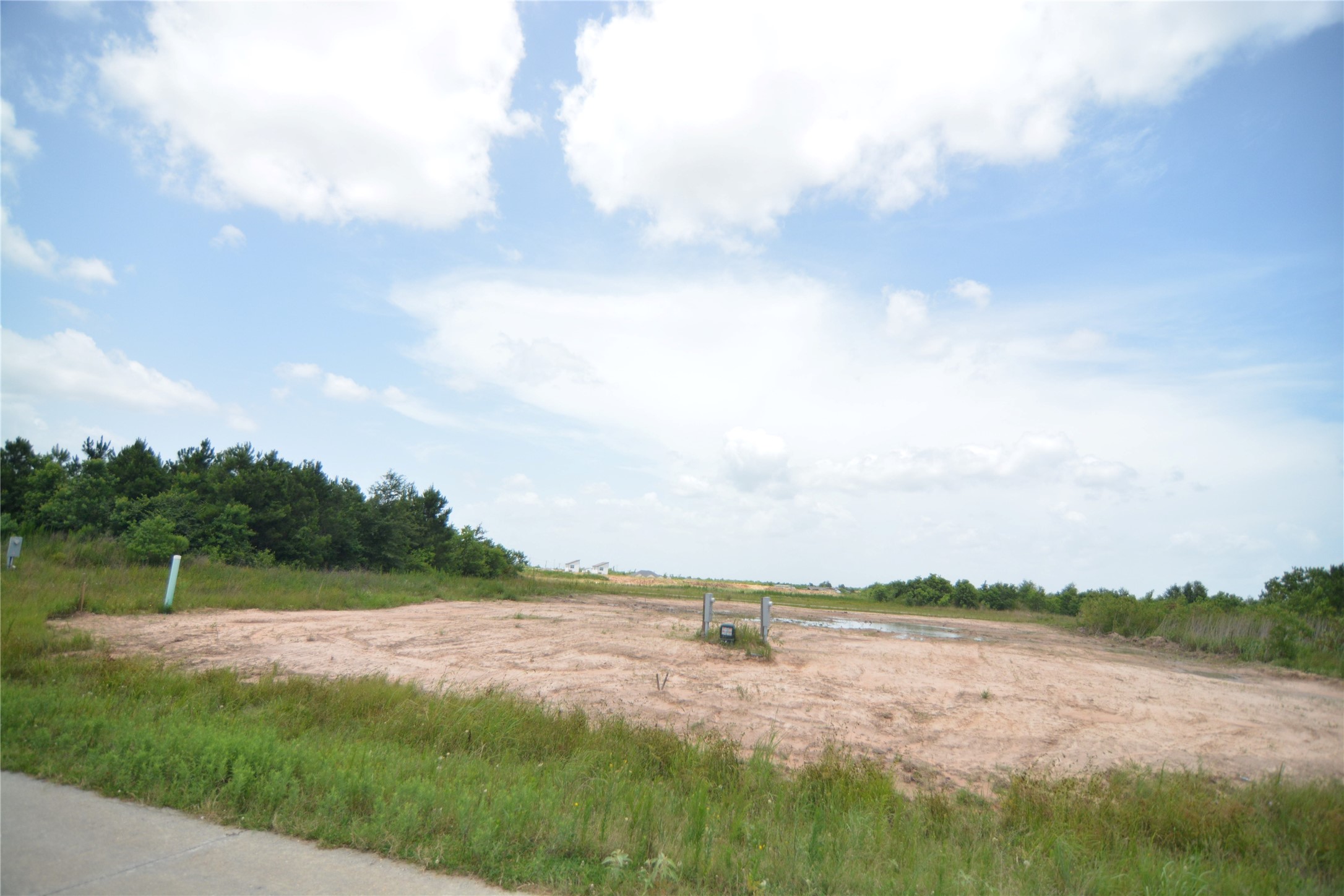 7714 Amanda Road Cleveland, TX 77327 - Photo 3 of 16 a view of lake with green field