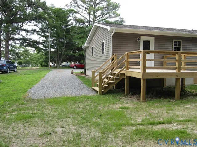 a view of a house with a yard and sitting area