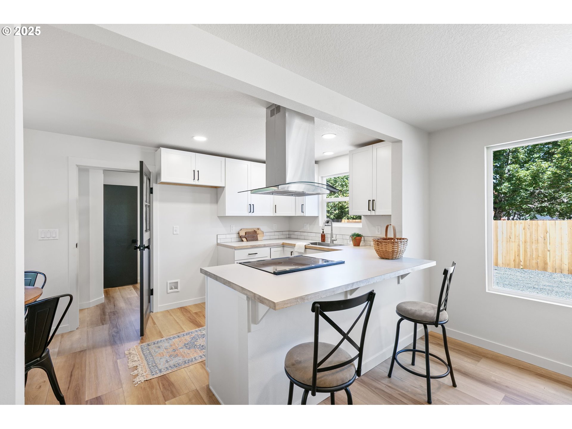 1938 7th Street Springfield, OR 97477 - Photo 12 of 48 a kitchen with stainless steel appliances kitchen island granite countertop a stove a refrigerator a sink a dining table and chairs