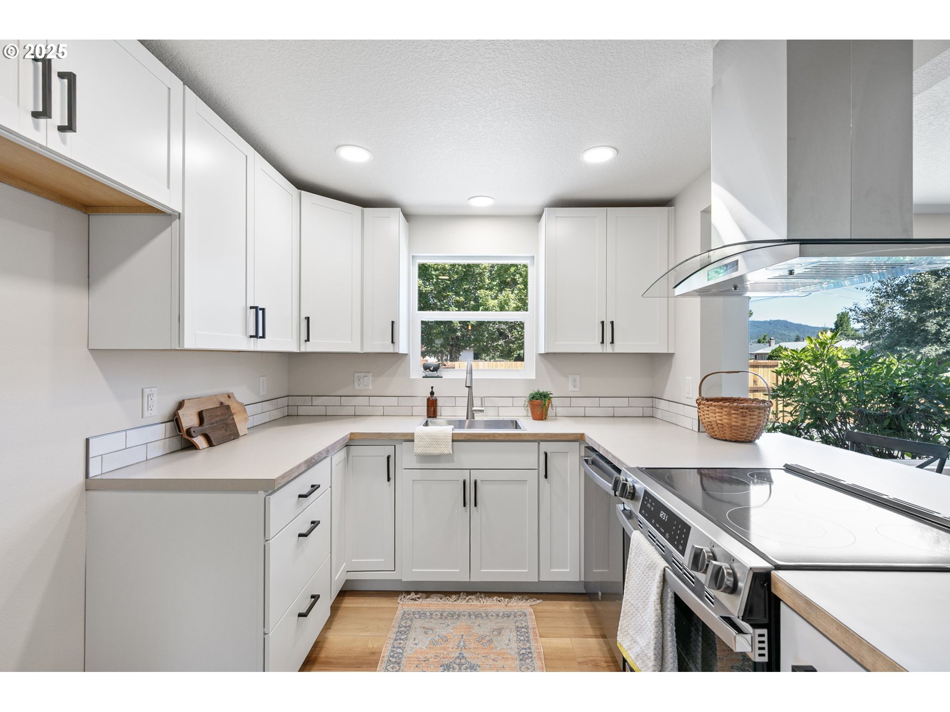 1938 7th Street Springfield, OR 97477 - Photo 14 of 48 a kitchen with a sink a stove and cabinets