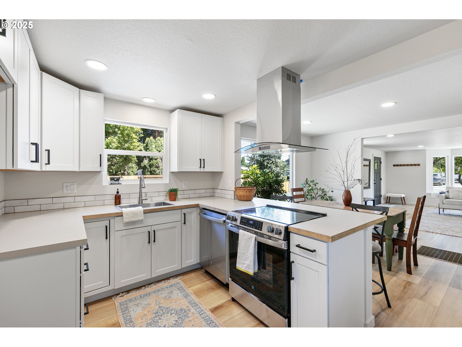 1938 7th Street Springfield, OR 97477 - Photo 15 of 48 a kitchen with a stove a sink a dining table and chairs