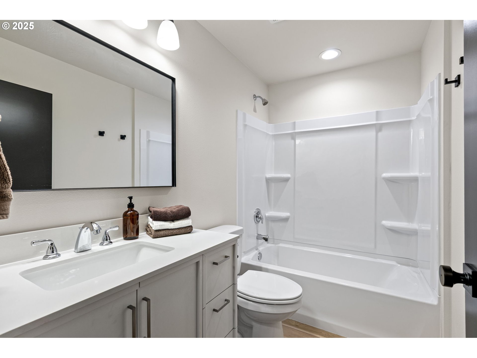 1938 7th Street Springfield, OR 97477 - Photo 28 of 48 a bathroom with a bathtub shower sink vanity mirror and toilet