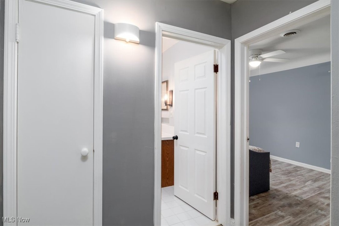 6401 West Ridgewood Drive Cleveland, OH 44129 - Photo 10 of 17 Corridor featuring light wood-style flooring and baseboards