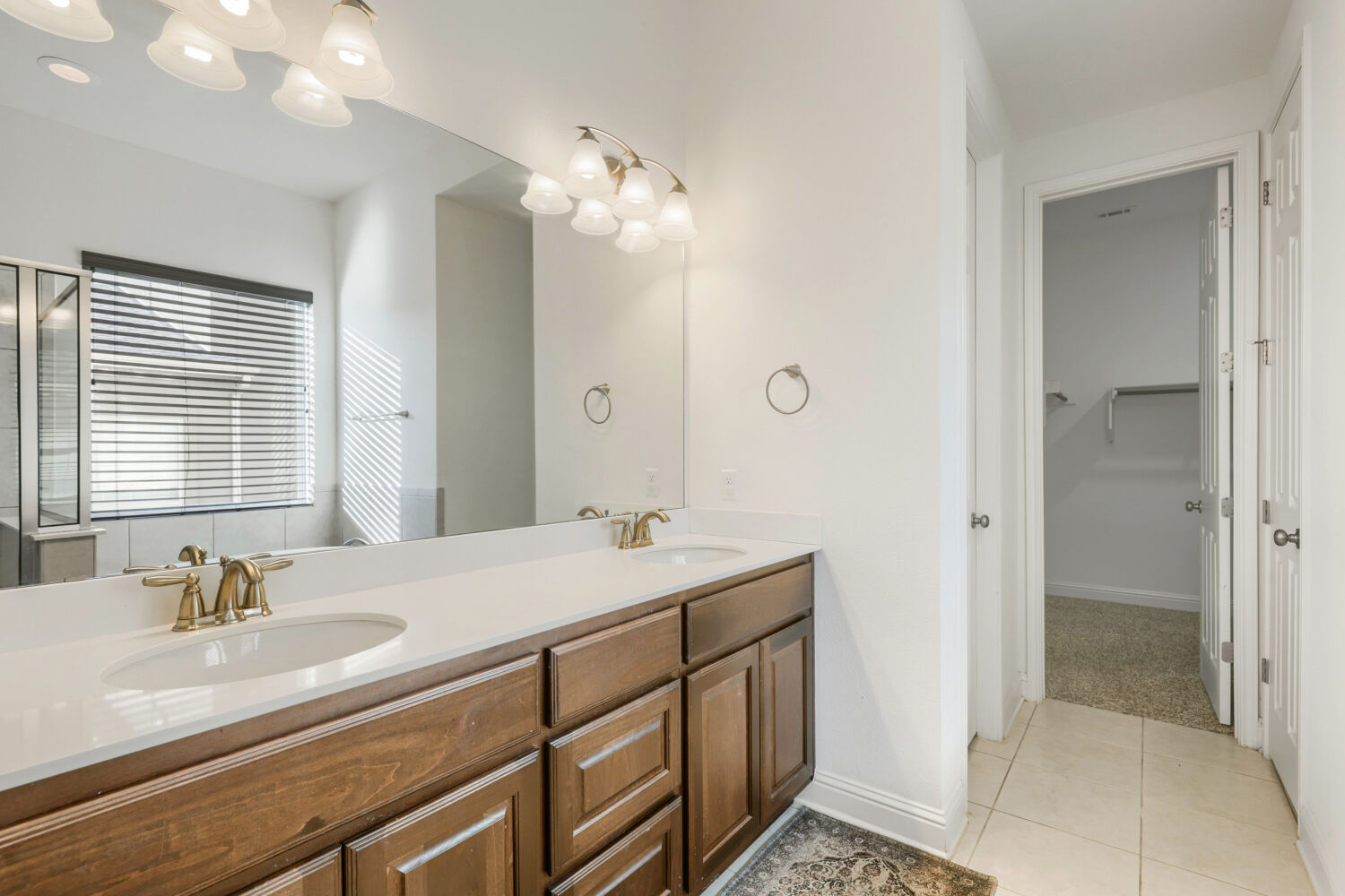 5821 Buchanan Draw Road Austin, TX 78738 - Photo 15 of 29 Double vanities with sleek countertops and abundant storage elevate this well-appointed bathroom.
