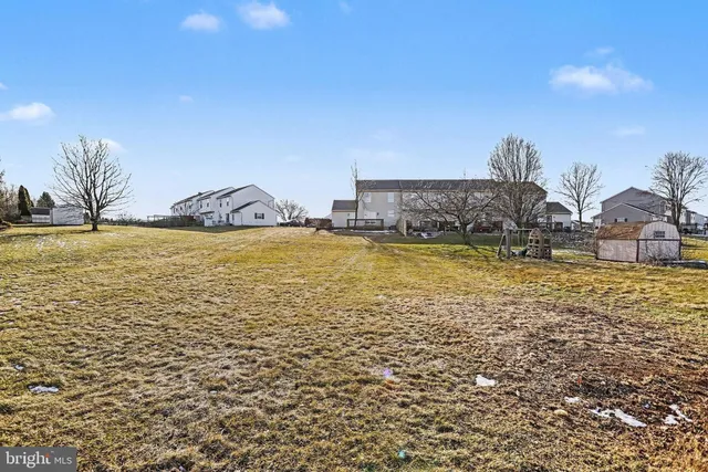 a view of a parking space with wooden fence