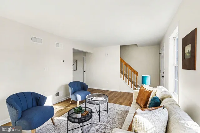 a living room with furniture and a chair